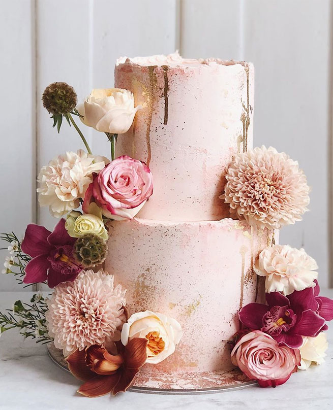 two tier pink wedding cake adorned with flowers, wedding cakes #weddingcake