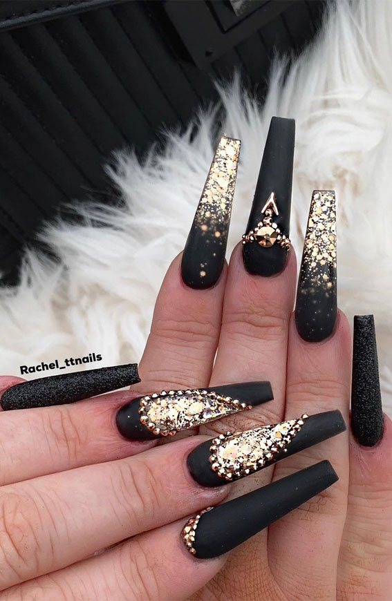 Premium Photo | A woman's nails with a silver and black nail art design