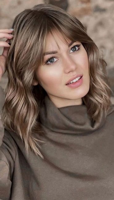 shoulder length hair with curtain bangs