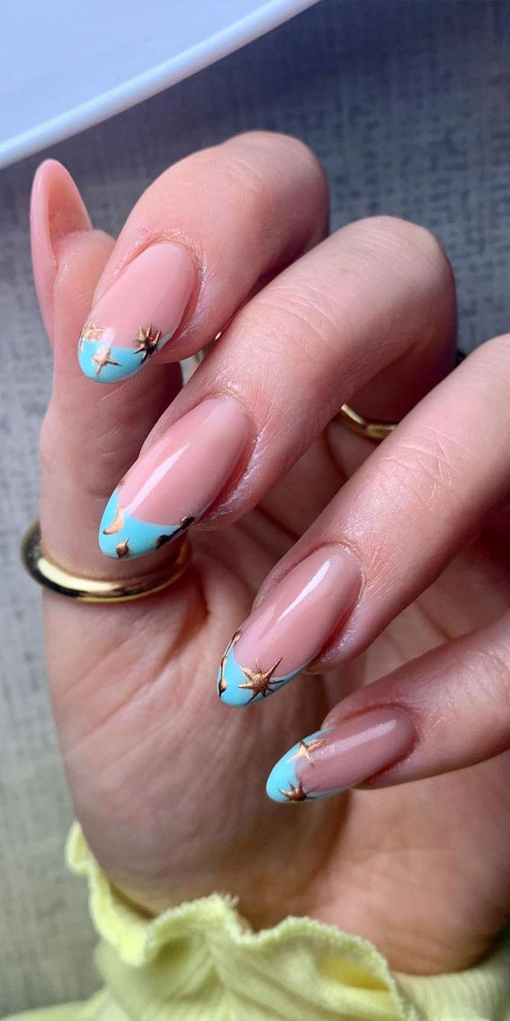 blue french tip nails, gold star blue french tip nails, blue french manicure, almond-shaped nails, french manicure with a twist