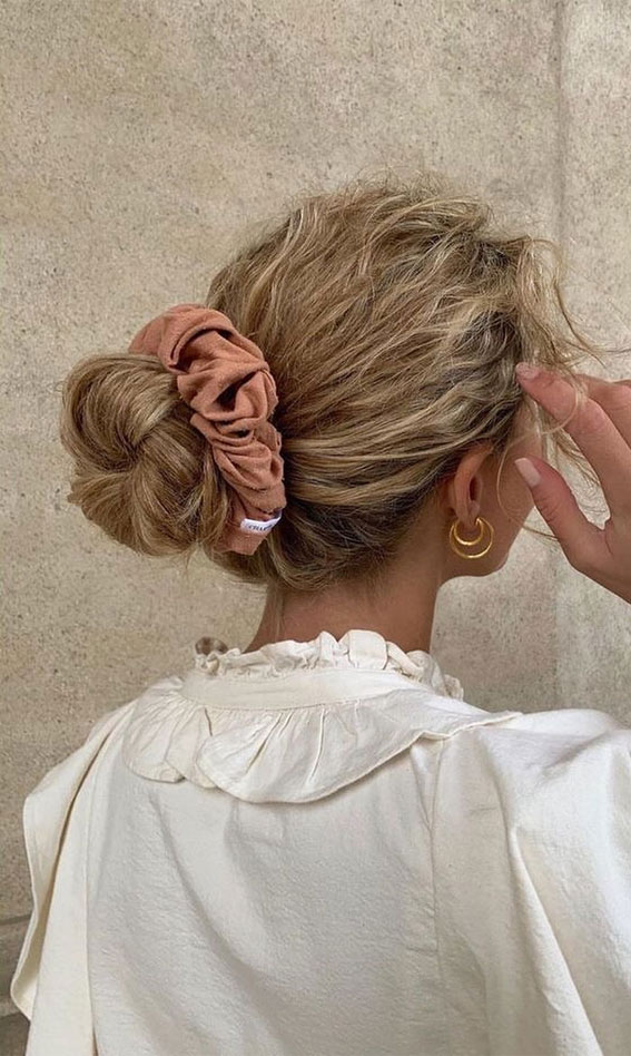 Cute Hairstyles That’re Perfect For Warm Weather : Blonde Curly Hair Bun with Scrunchie