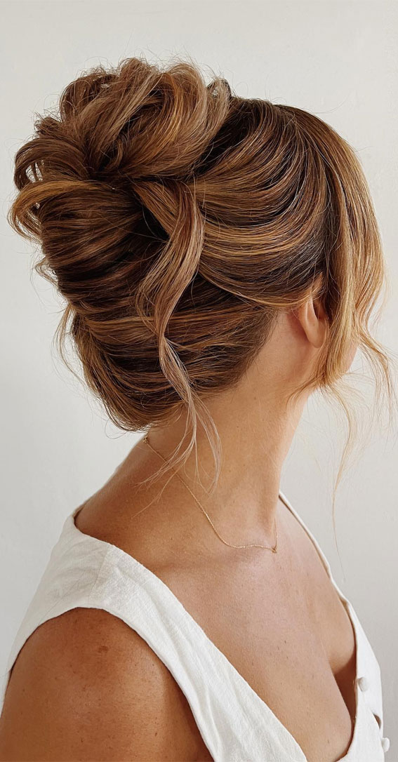Chic Updos To Elevate Your Hair Game : Messy Chignon with Strands of Hair Left Loose