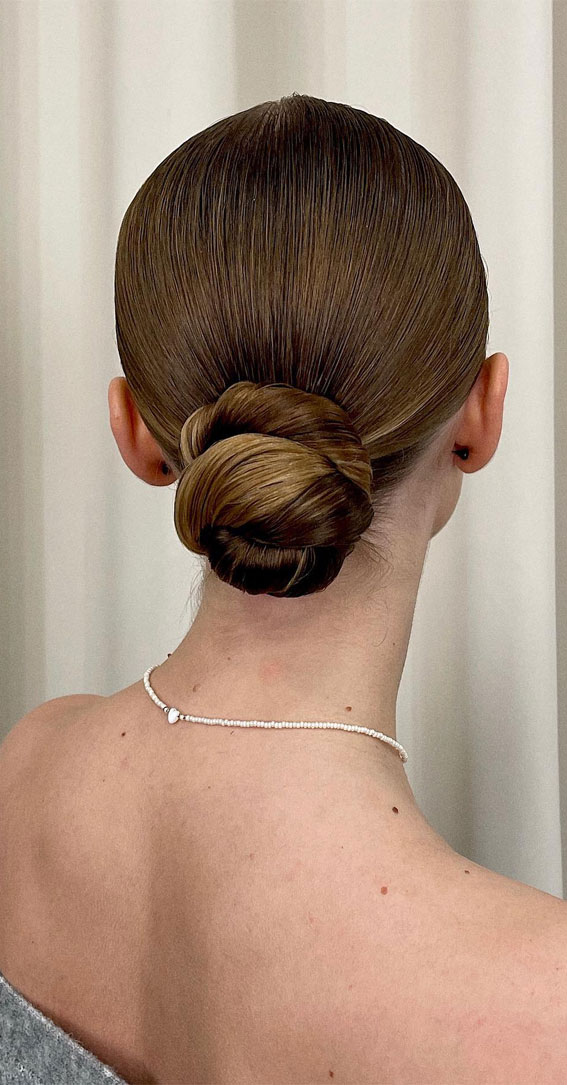 Elevate Your Look with Chic Hairstyling Ideas : Sleek Twisted Low Bun