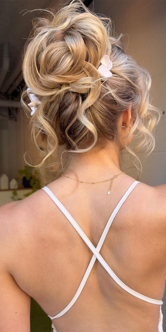 Elevate Your Look With Chic Hairstyling Ideas : Textured High Bun with White Flowers