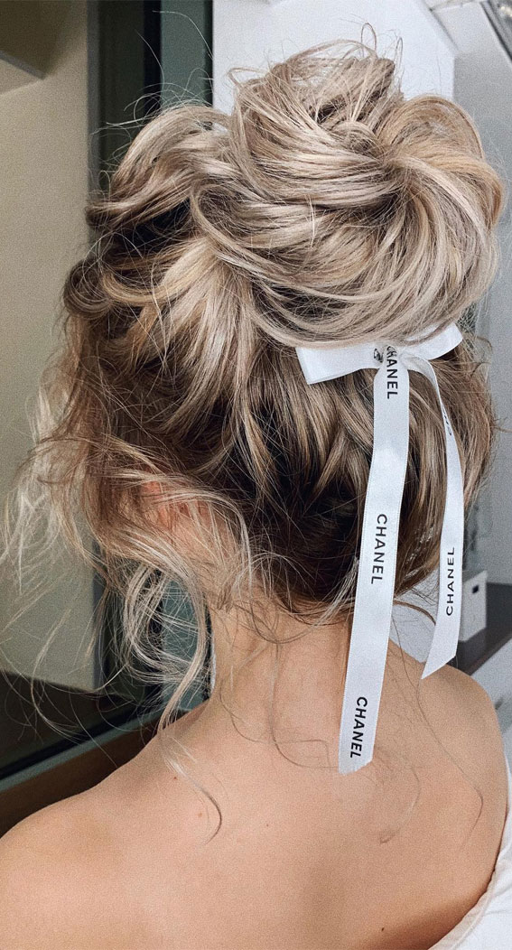 Elevate Your Look with Chic Hairstyling Ideas : Messy Twisted High Bun + Chanel Bow