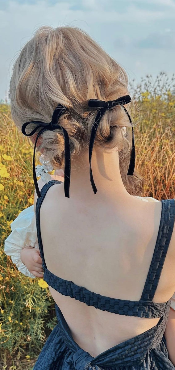 A Trendy Collection of Hairstyles Adorned with Chic Bows : Messy Low Bun with Velvet Bow