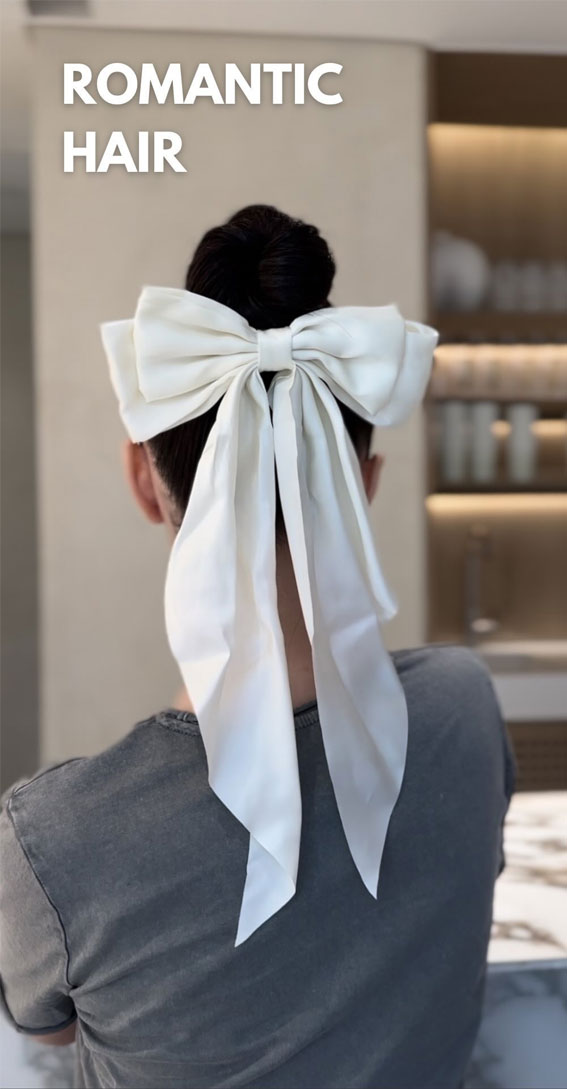 A Trendy Collection of Hairstyles Adorned with Chic Bows : Top Knot with Oversized White Bow