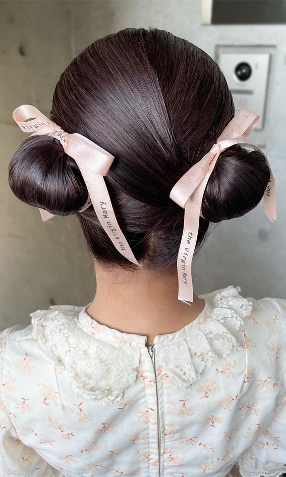 A Trendy Collection of Hairstyles Adorned with Chic Bows : Sleek & Modern Double Buns with Pink Bows
