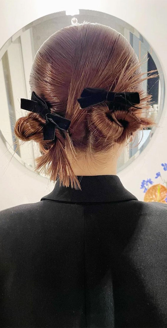 A Trendy Collection of Hairstyles Adorned with Chic Bows : Twisted Stylish Double Buns with Black Bows
