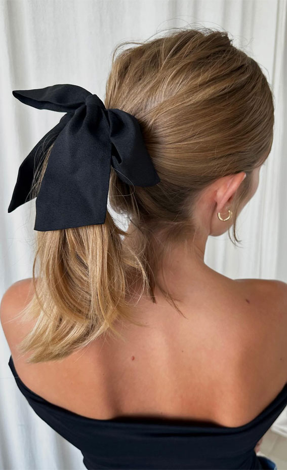 A Trendy Collection of Hairstyles Adorned with Chic Bows : Effortless Pony with Oversized Black Bow