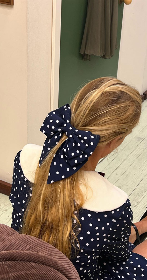 A Trendy Collection of Hairstyles Adorned with Chic Bows : Oversized Polka Dot Bow on Ponytail