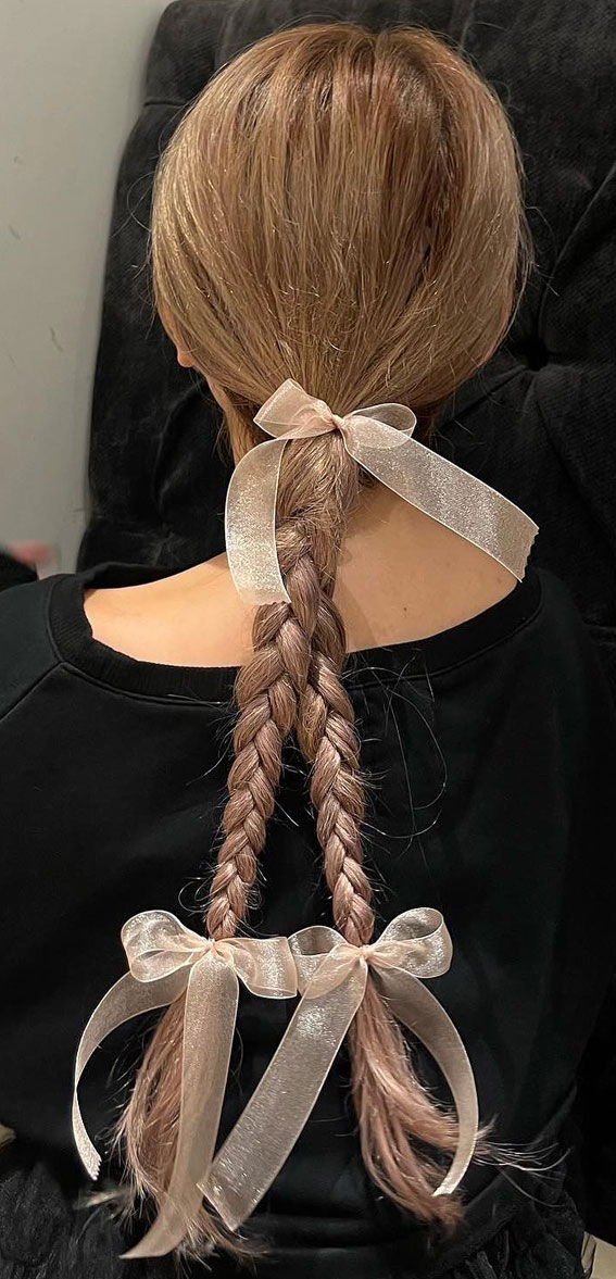 A Trendy Collection of Hairstyles Adorned with Chic Bows : Braids Tied with Sheer Pink Bows