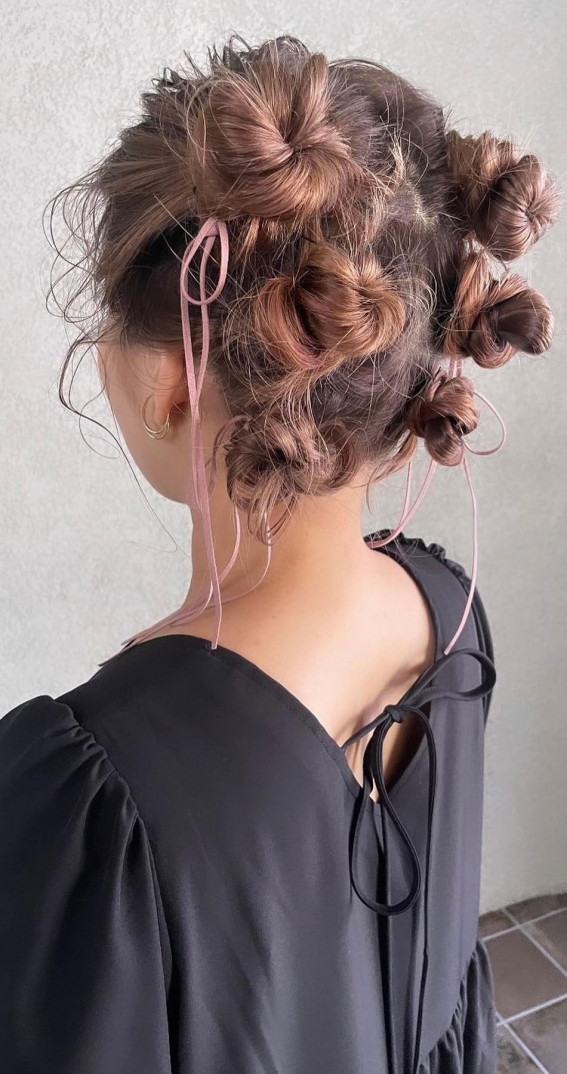 A Trendy Collection of Hairstyles Adorned with Chic Bows : Bow-topped Space Buns
