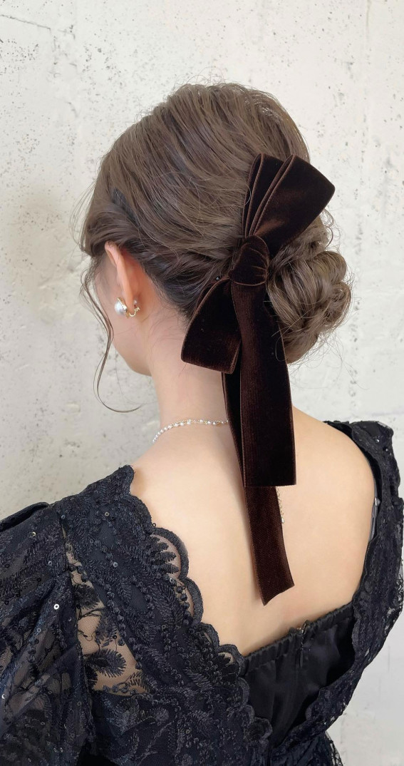 A Trendy Collection of Hairstyles Adorned with Chic Bows : Side Twisted Low Bun Topped with Bow