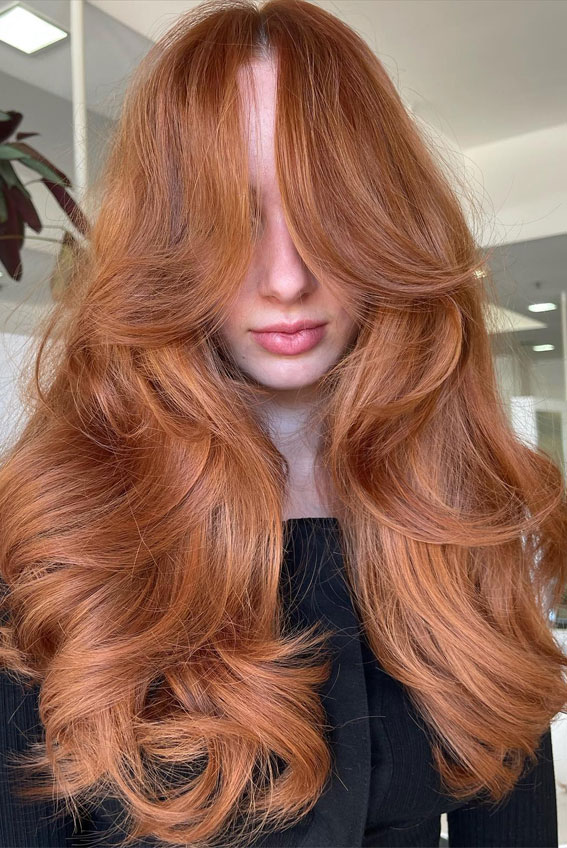 Enchanting Hair Colour Trends to Illuminate 2024 : Bright Copper Layers + Curtain Bangs