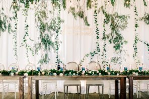 Disney-inspired wedding details - wedding quote on fabric wedding back drop + farm styled wedding table #weddingdetails #weddingdecor #weddingbackdrop #fabricdraped