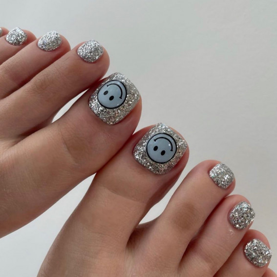 50 Trendy Pedicure Designs To Dress Up Your Toe Nails : Silver Glitter Toe Nails with Smiley Faces