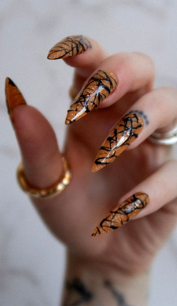 reflective glitter halloween nails, stiletto nails, orange glitter nails, halloween stiletto nails